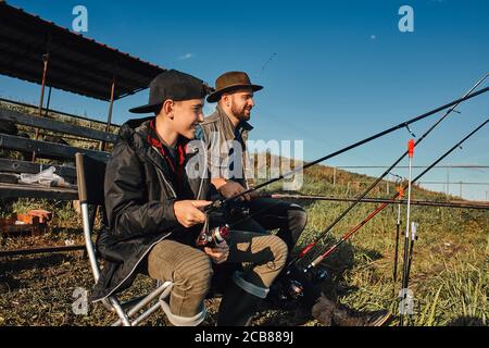 Father Teach Son How Fishing. Teen Boy Happy And Smile. This Is First  Fishing With Father. Background Blue Lake Stock Photo, Picture and Royalty  Free Image. Image 132748097.