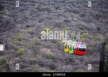 A ropeway trolley is carrying the devotees of Goddess Mansapurna Karni Mata in Udaipur from one end to another - Udaipur, Rajasthan, India Stock Photo