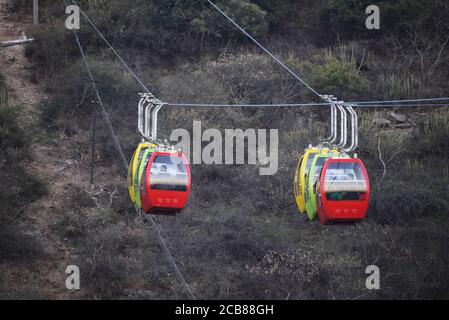 A ropeway trolley is carrying the devotees of Goddess Mansapurna Karni Mata in Udaipur from one end to another - Udaipur, Rajasthan, India Stock Photo