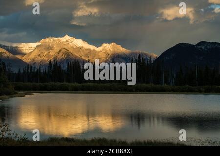 Evening skies over Cascade Range reflected in Vermilion Lakes, Banff National Park, Alberta, Canada