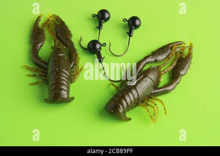 Closeup of rubber lobster fishing lures on green background Stock
