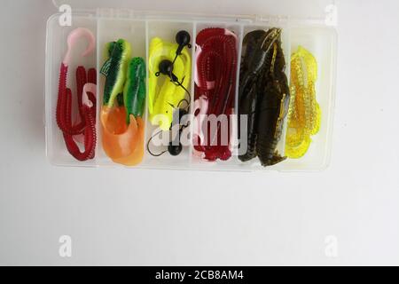 Overhead shot of colorful rubber worms fishing lures in a tackle