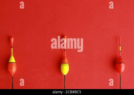 Closeup shot of fishing hooks isolated on an orange background Stock Photo