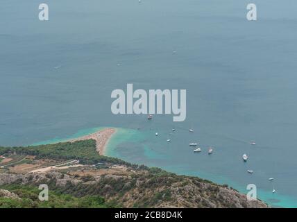 View of the famous Zlatni Rat beach on the island of Brac and the surrounding area. Boats anchored nearby visible Stock Photo