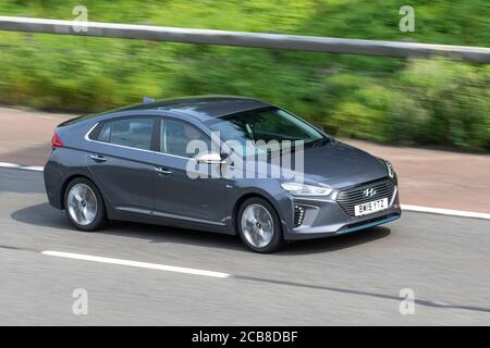 2019 grey Hyundai Ioniq Premium SE HEV S-A; Vehicular traffic moving vehicles, cars driving vehicle on UK roads, motors, motoring on the M6 motorway highway network. Stock Photo