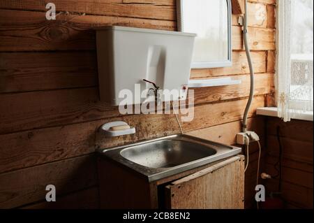 A luxurious living room, with comfortable furnishings, in a modern log cabin in the mountains. Stock Photo