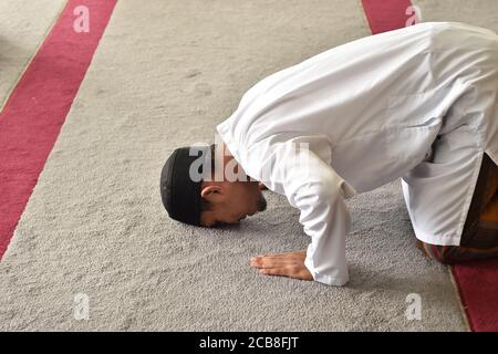 Muslim men praying in sujud / prostration posture Stock Photo - Alamy