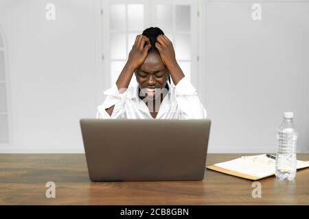 Frustrated despondent african american woman office worker getting fired from job concept Stock Photo