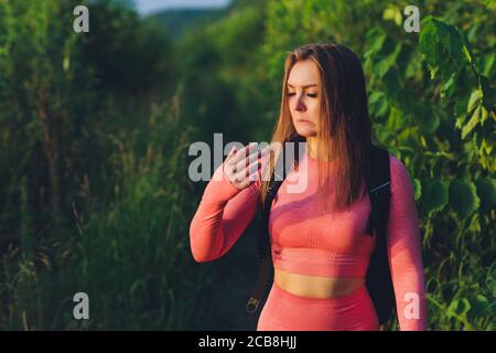 A woman with a sad suffering face shows a finger on which there is a callus, which worries her and prevents her from working. Medical concept. Stock Photo