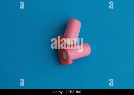 High angle closeup shot of pink and white jelly licorice on a blue background Stock Photo