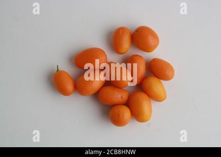 High angle shot of a few kumquats isolated on a white surface Stock Photo