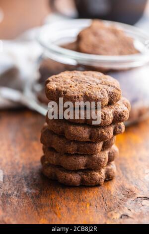Sweet cookies. Crunchy chocolate biscuits shape flower on wooden table. Stock Photo