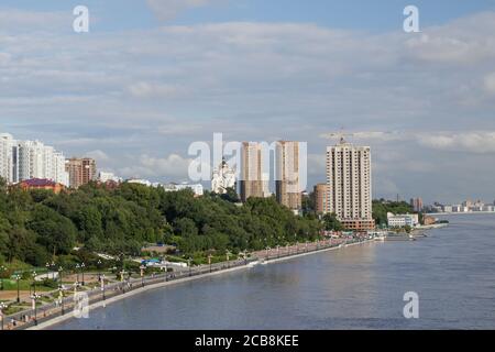 Amur River embankment in the sports and park complex of the city of Khabarovsk, Russia. On a summer day, people walk, play sports, sunbathe in the sun Stock Photo