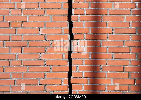 Red brick wall with a crack Stock Photo