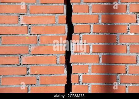 Red brick wall with a crack Stock Photo