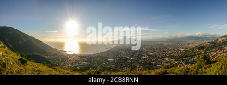 Panoramic photo of the total gulf of Naples, with mount Faito and mount Vesuvio, Warm light at the sunset. Stock Photo