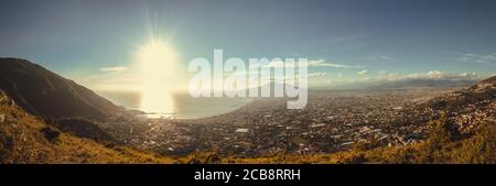 Warm light illuminating the gulf of Naples with vesuvio and the mount Faito ovr the city of Castellammare. Stock Photo