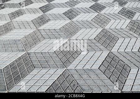 Close-up on the geometric tiles pattern of La Rambla promenade in downtown Alicante. Abstract texture geometric background. Stock Photo