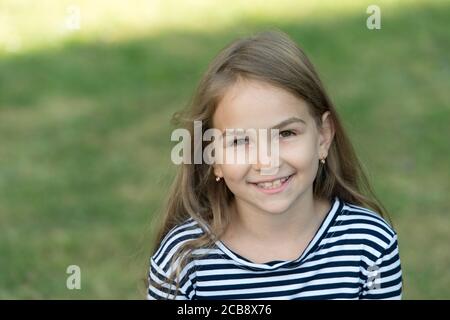 Smile that makes lasting impression. Happy child smile summer outdoors. Dental health. Oral hygiene. Cavities and teeth decay prevention. Dental fillings. Pediatric dentistry, copy space. Stock Photo