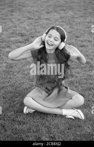 Practicing her singing. Happy singer sing song outdoors. Little girl enjoy singing to music. Vocal exercises. Enjoying solo singing. Summer fun. Discover your singing voice. Stock Photo