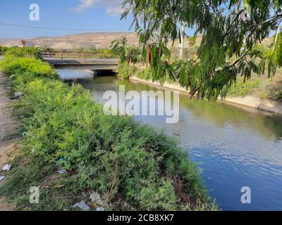 The King Abdullah Canal is the largest irrigation canal system in Jordan and runs parallel to the east bank of the Jordan River. Stock Photo