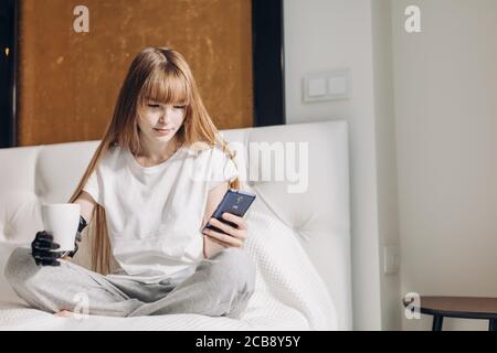 The young girl spending her free time with gadget at home, close up photo, entertainmnet Stock Photo