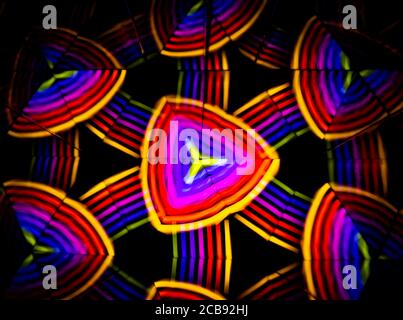 3D rendering or 3D rendering. Kaleidoscopic three-dimensional image. Symmetry with colored lights on a black background. Stock Photo
