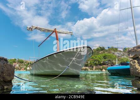 Beautiful picturesque view of an old ship docked in the tiny port of Bobovisca on the island of brac. Lights reflecting of the water and the boat, cry Stock Photo