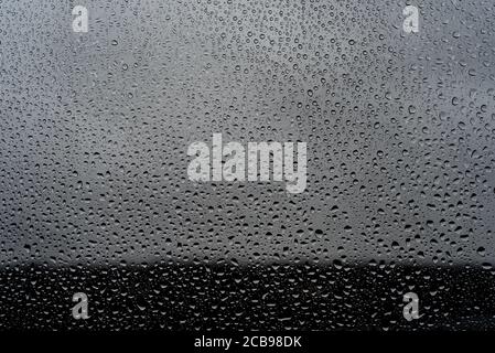 Raindrops on window against a blurry backdrop during storm Ciara, February 2020, London. Stock Photo