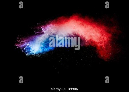 Red blue dust particles explosioon on black background.Red blue powder splash. Stock Photo
