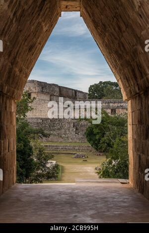 The main entrance into the Nunnery Quadrangle is through a corbel arch doorway in the center of the south building in the pre-Hispanic Mayan ruins of Stock Photo