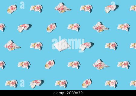 Lot of used and one clean napkins on blue background. Concept of exclusiveness, uniqueness. Trendy isometric pattern with soft shadow. Stock Photo
