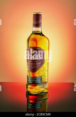 Tel Aviv, Israel - August 2, 2020: A bottle of luxury whiskey Grants on a gradient background with reflection. Stock Photo