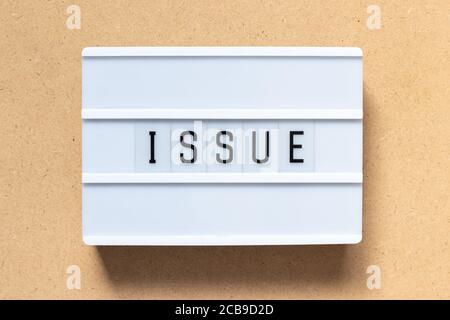 White lightbox with word issue on wood background Stock Photo