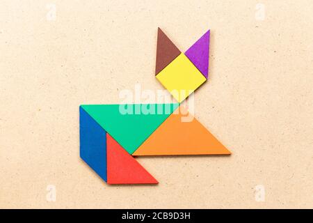 Color tangram puzzle in lying down cat shape on wood background Stock Photo  - Alamy