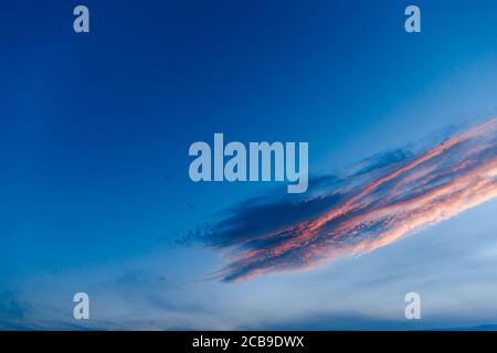 Dark blue sky before sunset with beautiful awesome clouds. Colorful Sunset Background Stock Photo