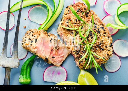 Cooked tuna steak in sesame with vegetables.Fish steak Stock Photo