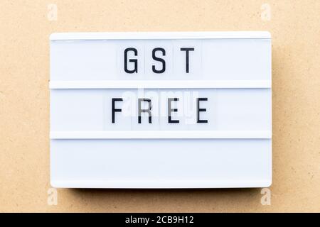 White lightbox with word GST (Abbreviation of Goods and Service Tax) free on wood background Stock Photo