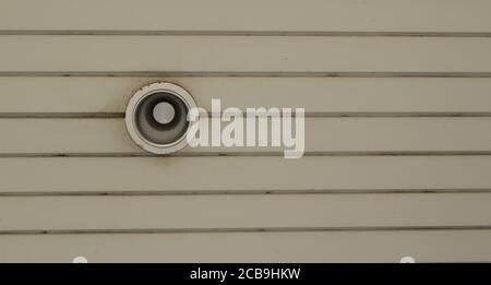 Selective focus on LED lamp installed in old light fixture on wooden ceiling of canopy Stock Photo