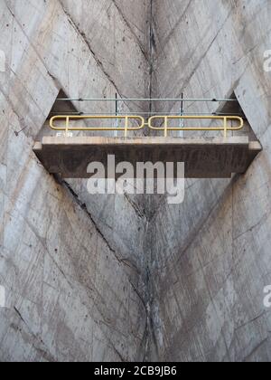 Vertical low angle shot of a short bridge in between the corner of two buildings Stock Photo