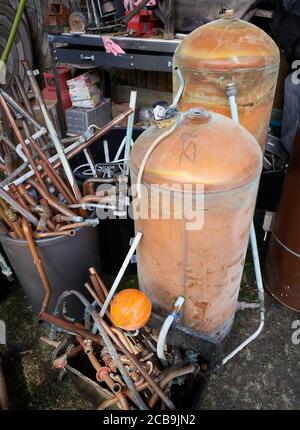 Disused hot water cylinders waiting for recycling. Stock Photo