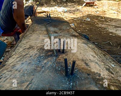 Construction Worker are preparing steel poles for building house. Stock Photo