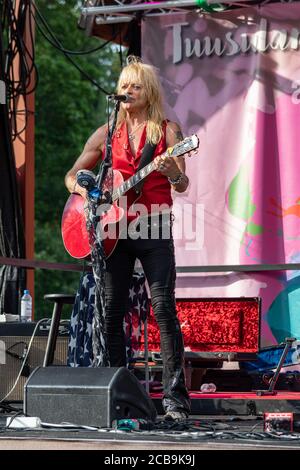 Michael Monroe on stage playing acoustic guitar at Krapin Paja open-air concert in Tuusula, Finland Stock Photo