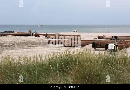 Pipeline tubes for sand replenishment. Bach nourishment to make wider beaches to reduce storm damage to coastal structures. Hel, Poland. Stock Photo