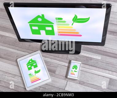 Home energy efficiency concept shown on different information technology devices Stock Photo