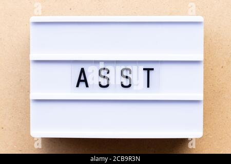Lightbox with word asst (abbreviation of assistant) on wood background Stock Photo