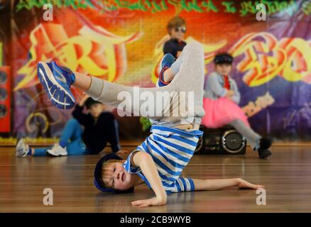 little boy in a unique breakdance position, street dancer, breakdance kids Stock Photo