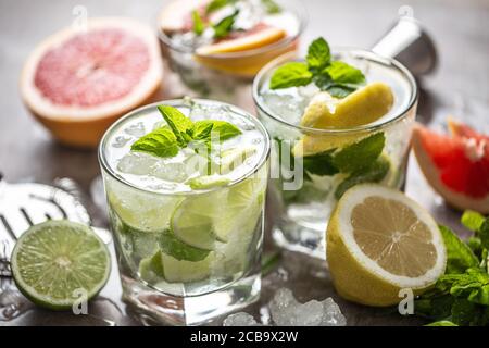 Three colorful gin tonic cocktails in whiskey glasses on bar counter in pup or restaurant Stock Photo