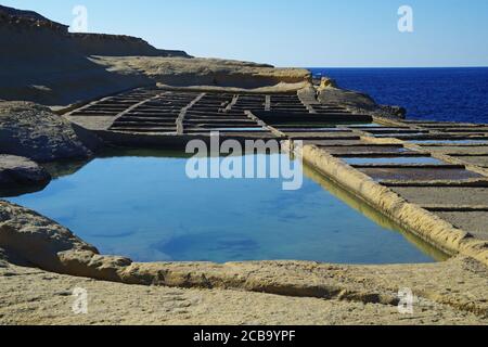 Salt Pans on the coast at Qbajjar near Marsalforn Bay Bay Gozo Malta Stock Photo