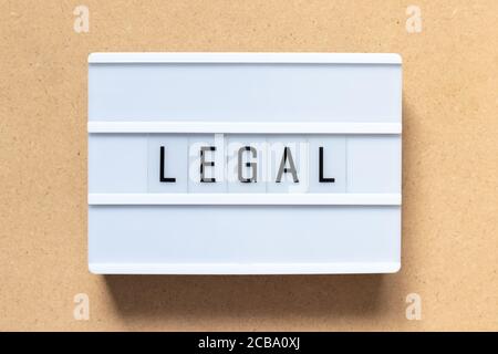 White lightbox with word legal on wood background Stock Photo